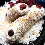 Bring a burst of holiday flavour to your celebrations with our CranCoconut Cannoli, the perfect blend of sweet and tart in every bite. This seasonal twist on the classic Italian dessert features a crisp, golden cannoli shell rolled in toasted coconut shreds and filled with a creamy blend of velvety ricotta and coconut, offering a rich yet refreshing filling that’s full of festive cheer.&nbsp; The natural sweetness of dried cranberries adds a bright, tangy contrast.