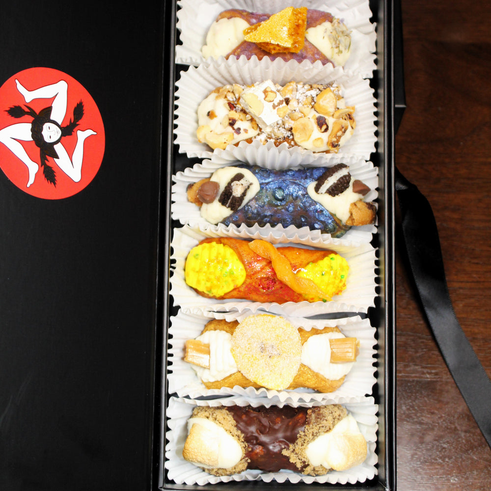 New Year's SetBox of 6 Gourmet Cannoli. This carefully curated box features six unique and innovative flavour combinations that take the classic Italian dessert to new heights. Each cannoli is filled with a luxurious, creamy filling made from the finest ingredients, offering a twist on tradition that will thrill your taste buds with every bite!&nbsp; Included in the SetBox are:&nbsp;


Top to bottom:&nbsp; The Lavender Honey, The Toronne, The Cookie Monster, The Mango, The Banoffee, and The S'Mores.